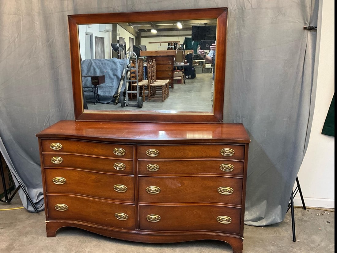 Chest of Drawers and Mirror: Mid - twentieth century mahogany Hepplewhite style chest/dresser of four drawers by four drawers with attached mirror. Made by Bassett Furniture Company. Lower front with several areas of missing