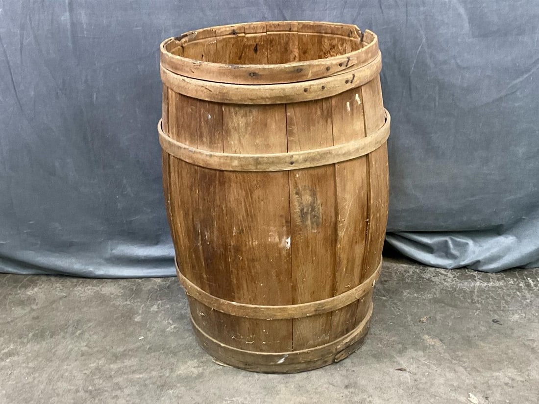 Staved Barrel: Early twentieth century handmade wooden staved barrel. No lid. Used condition, otherwise good condition. Measures 19 inches in diameter x 28.5 inches tall.