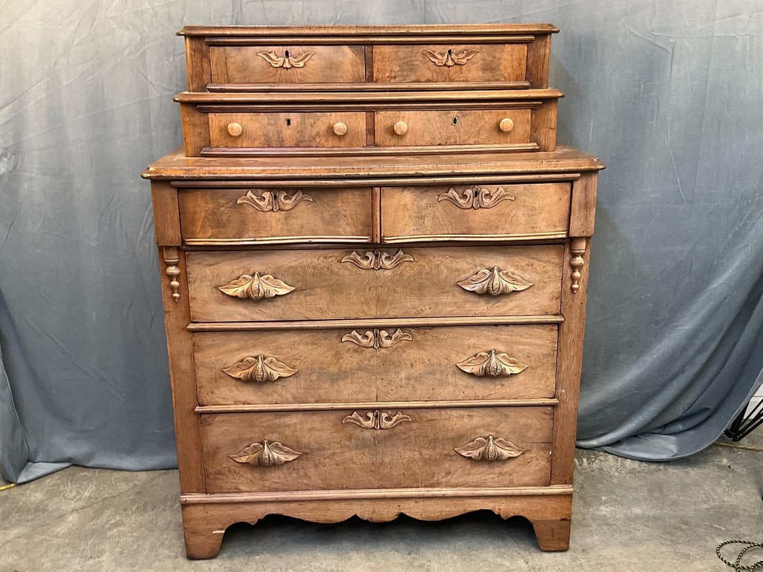 Victorian Chest of Drawers: Late 19th century Victorian pine and walnut chest of nine drawers. Applied wooden floral pulls with decorative drop pendants to stiles. Veneered burl walnut drawer fronts with oak, white pine, and