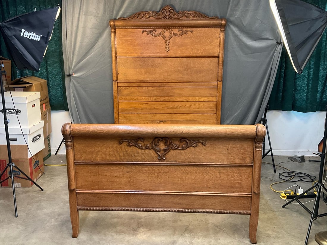 Victorian Oak Bed: Late 19th century - early 20th century quarter sawn oak bed with carved floral crest and applied floral carvings to a paneled headboard. Five heavy thick bed slats. Good condition. Inside rail measure