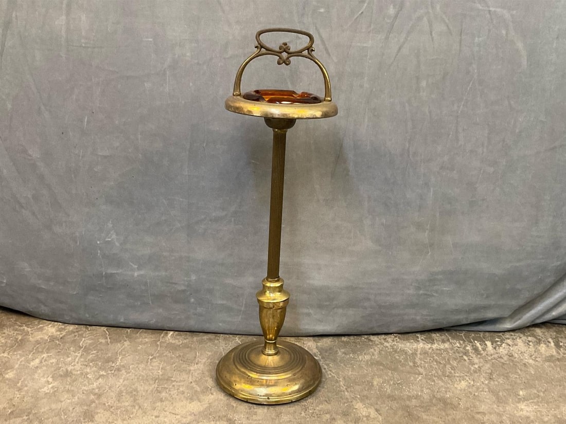 MCM Smoking Stand: Mid 20th century brass and brass plated metal smoking stand with amber glass ashtray. Good condition. Base measures 9.5 inches in diameter x 29 inches tall.
