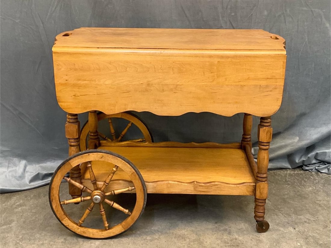 Tea Cart: Mid - twentieth century maple tea cart with drawer and wooden wheels. Good condition. Measures 34 inches wide x 19.5 x 28.25 inches tall.