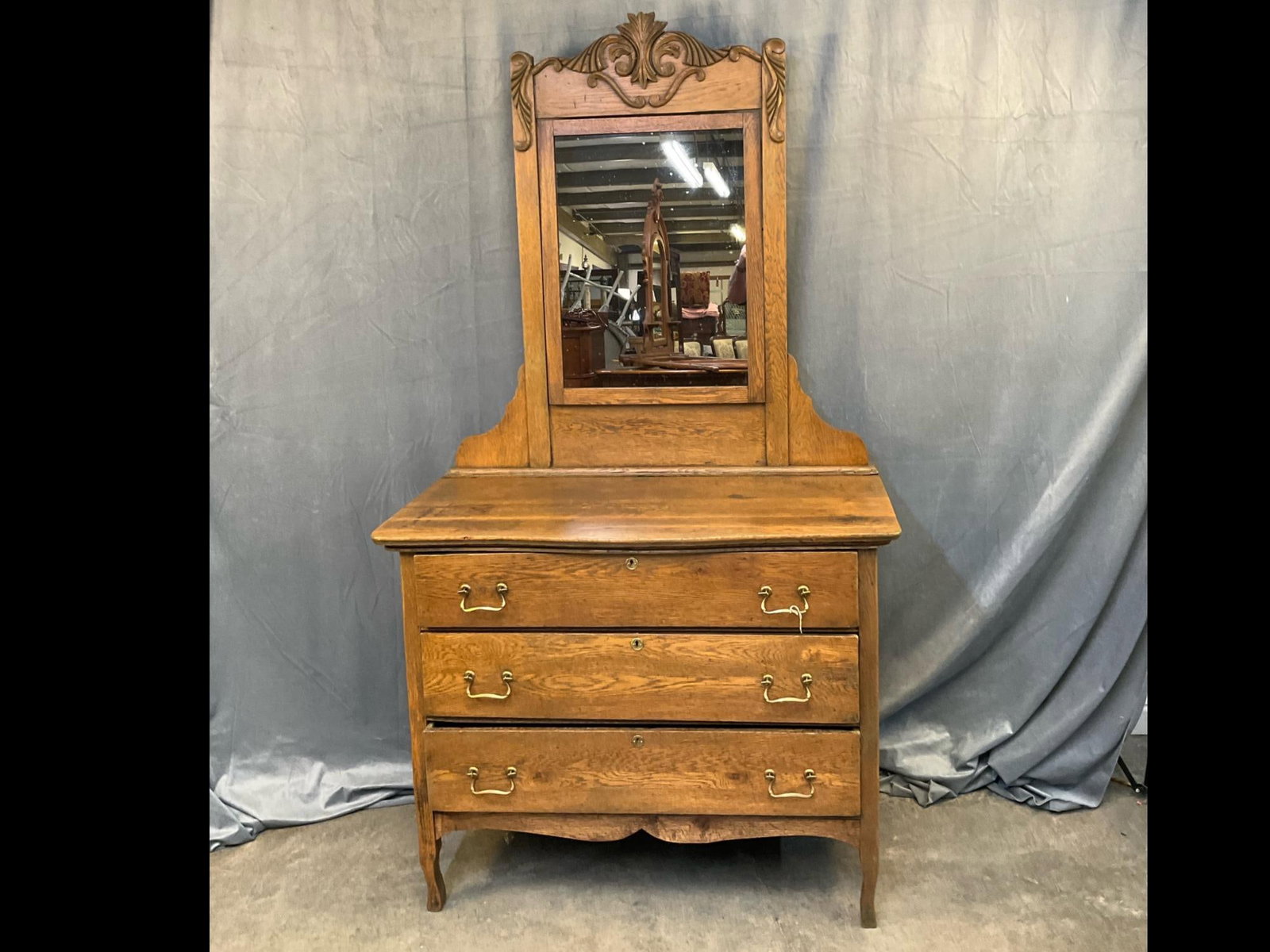 Oak Dresser: Early twentieth century oak chest of three drawers and mirror with applied acanthus leaf carving. Good condition. Measures 42 inches wide x 19.25 x 75.25 inches tall.