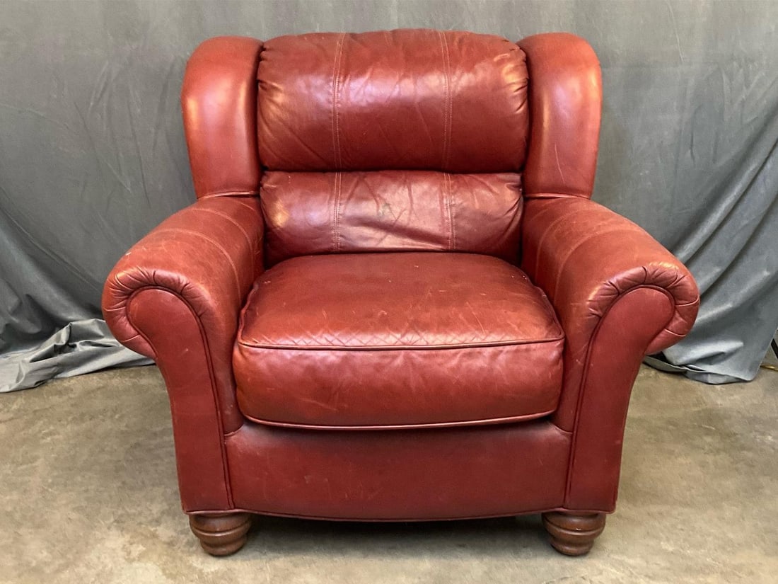 Leather Lounge Chair: Late twentieth century red leather lounge chair. Some scratches and stains to leather, otherwise good condition. Measures 42 inches wide x 37 x 37.5 inches tall.