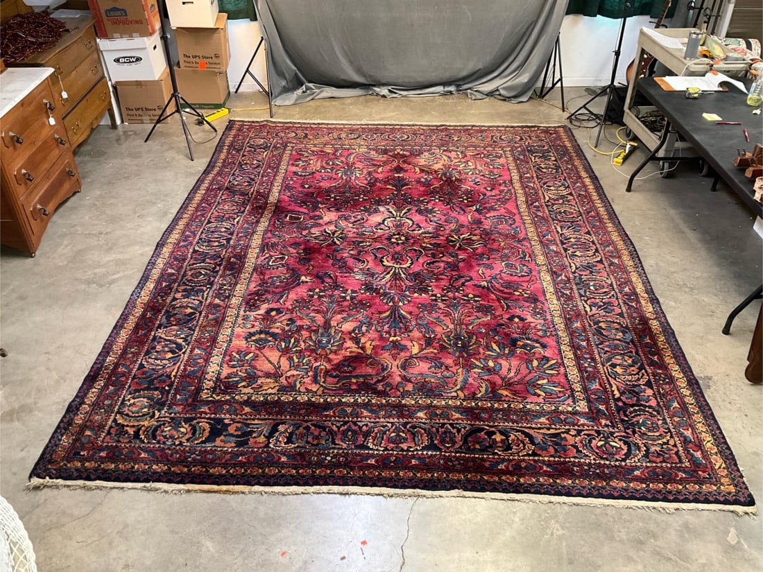 Oriental Rug: Mid - twentieth century vintage oriental carpet. Several areas of carpet loss due to moth damage, worn edges, several areas of color mixing, color loss and staining due to water damage, and in need