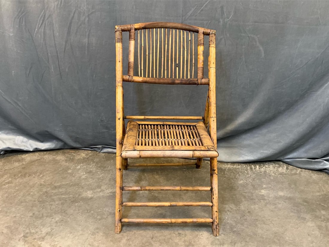 Bamboo Chair: Late twentieth century British Colonial Style bamboo chair. Seat needs reattaching to frame with weathered finish to bamboo. Measures 18.5 inches wide x 19 x 33 inches tall unfolded in seating
