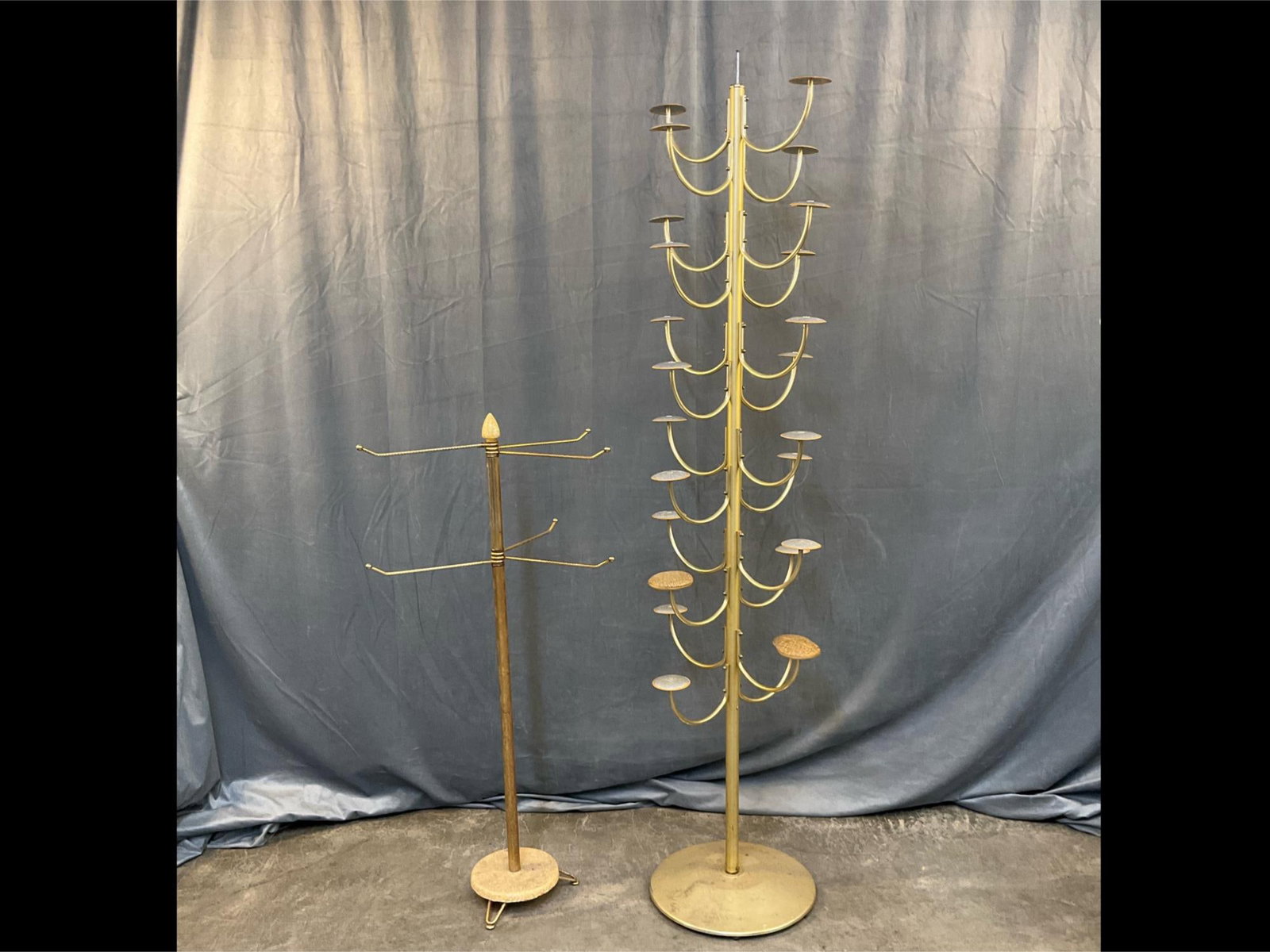MCM Hat Stand: Two mid-20th century vintage hat stands. Taller stand with rotating pole and smaller stand with adjustable arms. Taller stand missing finial, otherwise good condition. Taller stand measures 15 inches