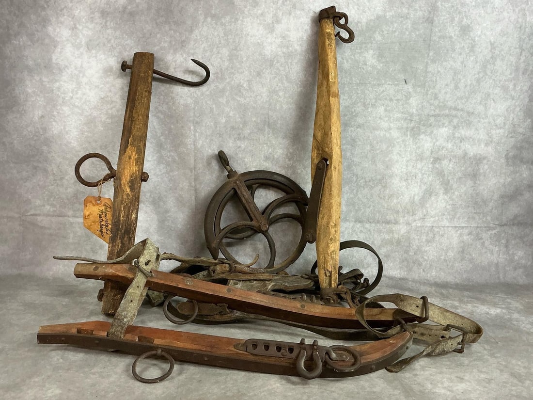 Rustic Farming Finds: Five late 1800's to early 1900's items. Two meat hangers, iron well pulley, and set of bull blinders. Includes U S Hame Company yoke harness. Items are worn and rusty. Meat hangers measures 22 inches