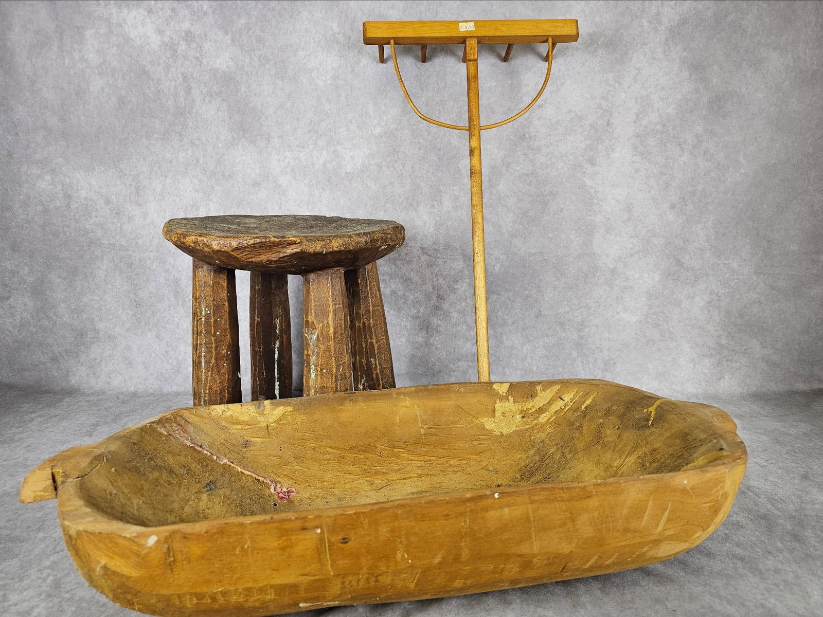 Carved Dough Bowl & More: Modern hand carved dough bowl, four legged stool made in India, and a miniature hay rake. Dough Bowl has some repairs, stool has wear. Dough Bowl measures 9.5 inches wide x 5.25 x 26 inches long.