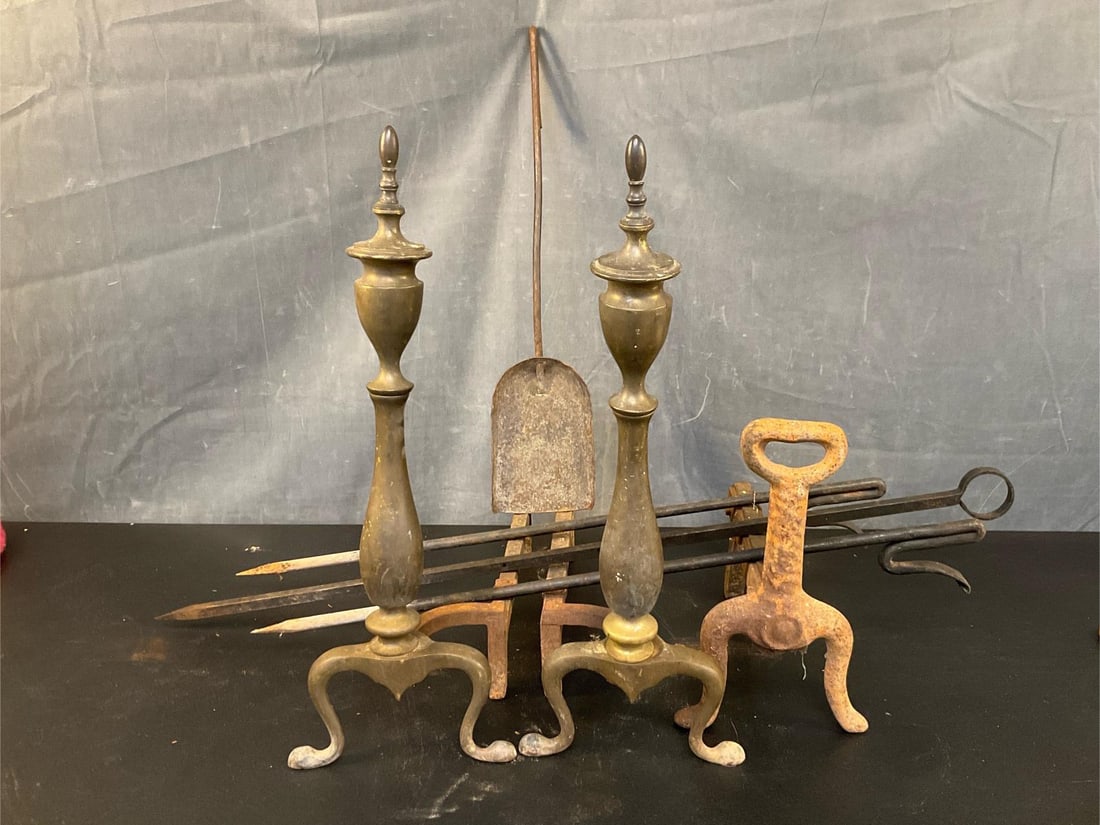 Wrought Iron Hearth Cooking: Lot of seven total Vintage/Antique fireplace items. One pair of brass Federal Style twentieth century andirons marked Bennett. One single 19th century cast iron andiron with old repair to billet. One