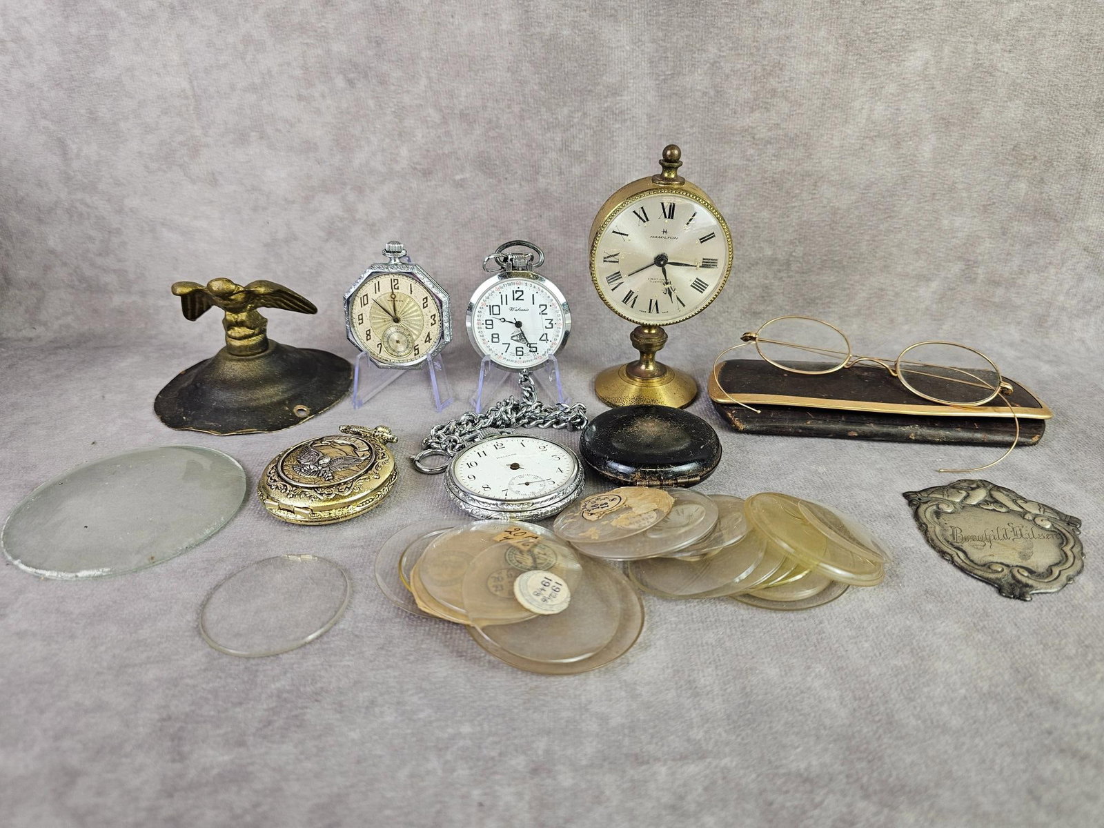 Pocket Watches & More: Large group of replacement watch crystals, some glass and some plastic. Modern and vintage pocket watches, not running, and missing crystal and hands. Hamilton desk clock that runs for a few seconds