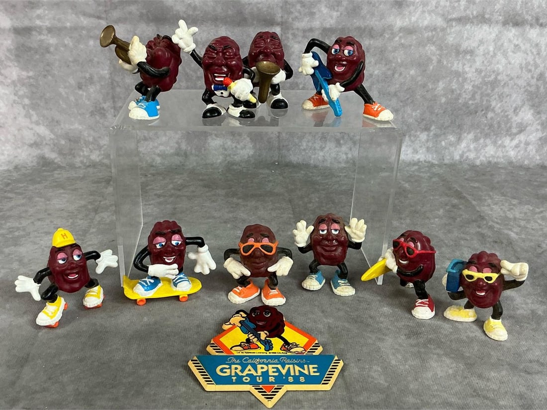 Collectible California Raisins: Ten figures and a badge from 1987-1988. Collectible California hard plastic raisin figures playing instruments, and enjoying summer fun activities. Includes Tour '88 pin. In good condition. Pin