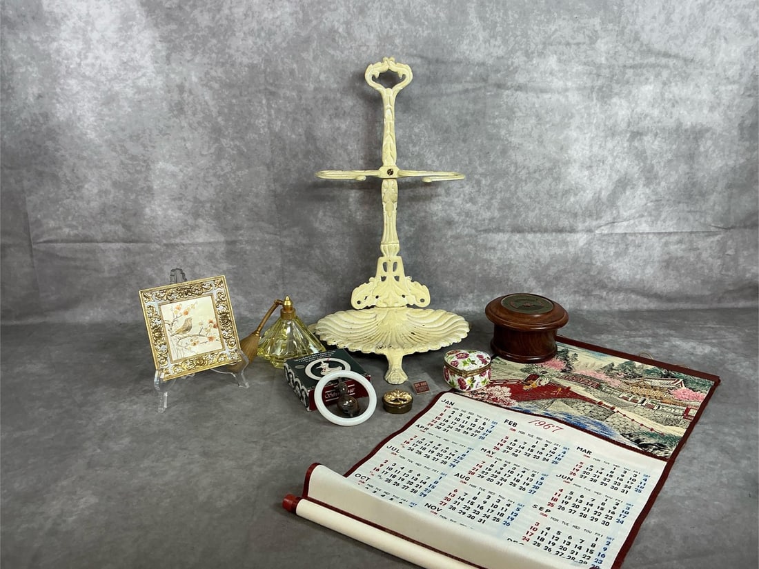 Cast Aluminum Stand, Music Box, Perpetual Calendar & More: Eight early to late 1900s lot. Cast aluminum stand with shell base for hearth tools or soap & towels, Linden Sankyo bird frame music box plays "Feelings ", and perpetual calendar with brass dial in