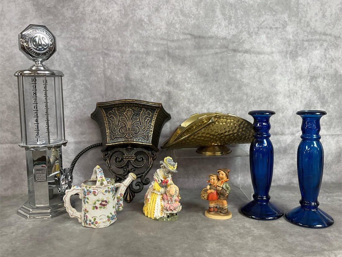 Decorative Collectibles: Eight vintage items. Dodinger “Fill ‘Er Up” dispenser, two cobalt blue candle holders, Homeco wall pocket, Hummel figurine titled “Surprise “, and more. Items in good condition. Gas