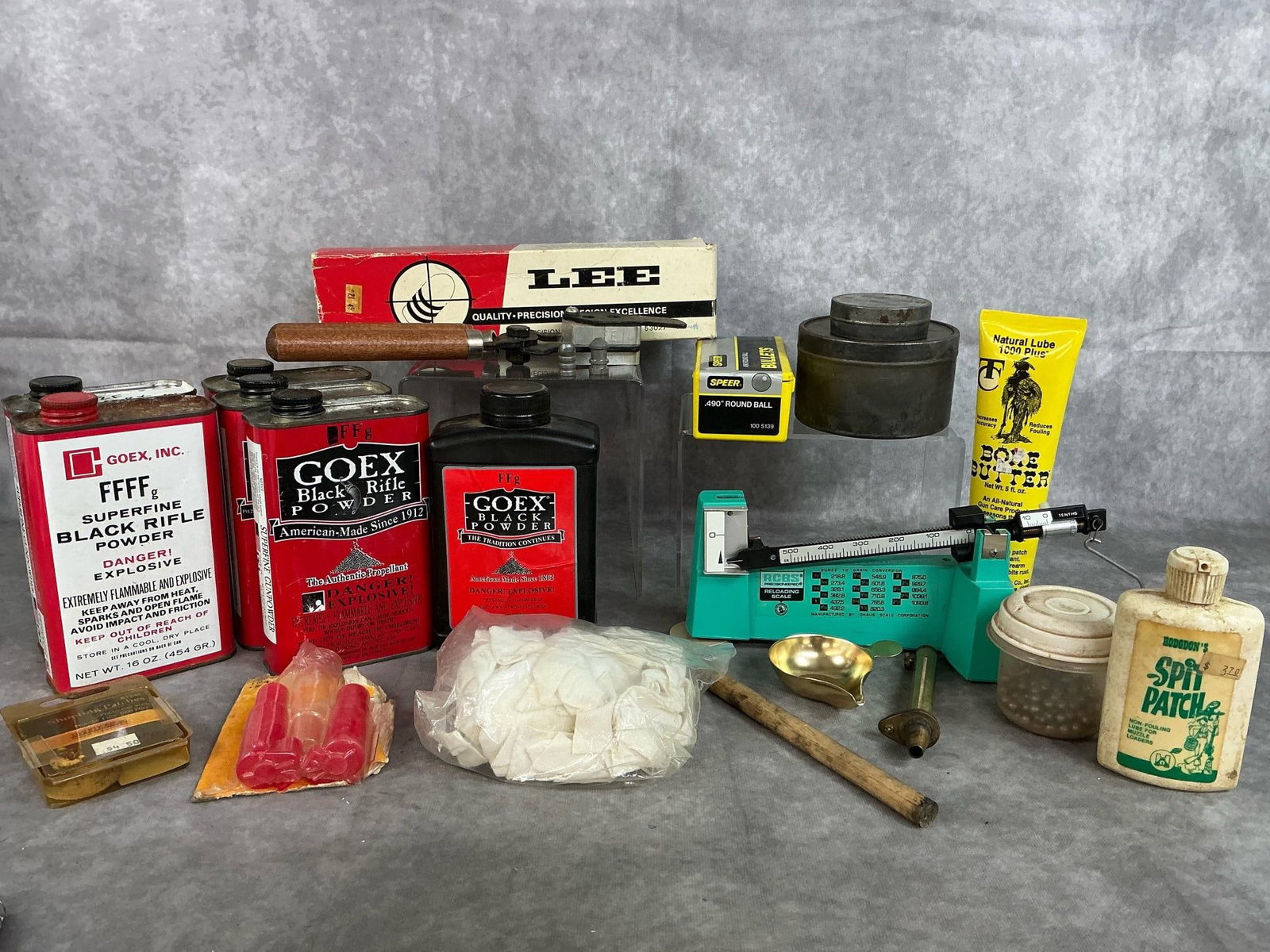 Black Powder Loading Supplies: Lot of supplies for loading black powder guns. Includes bullet mold by Lee, reloading scale, six cans of partial to full Goex black powder, .490 round ball bullets, tins, patches, bore butter, and