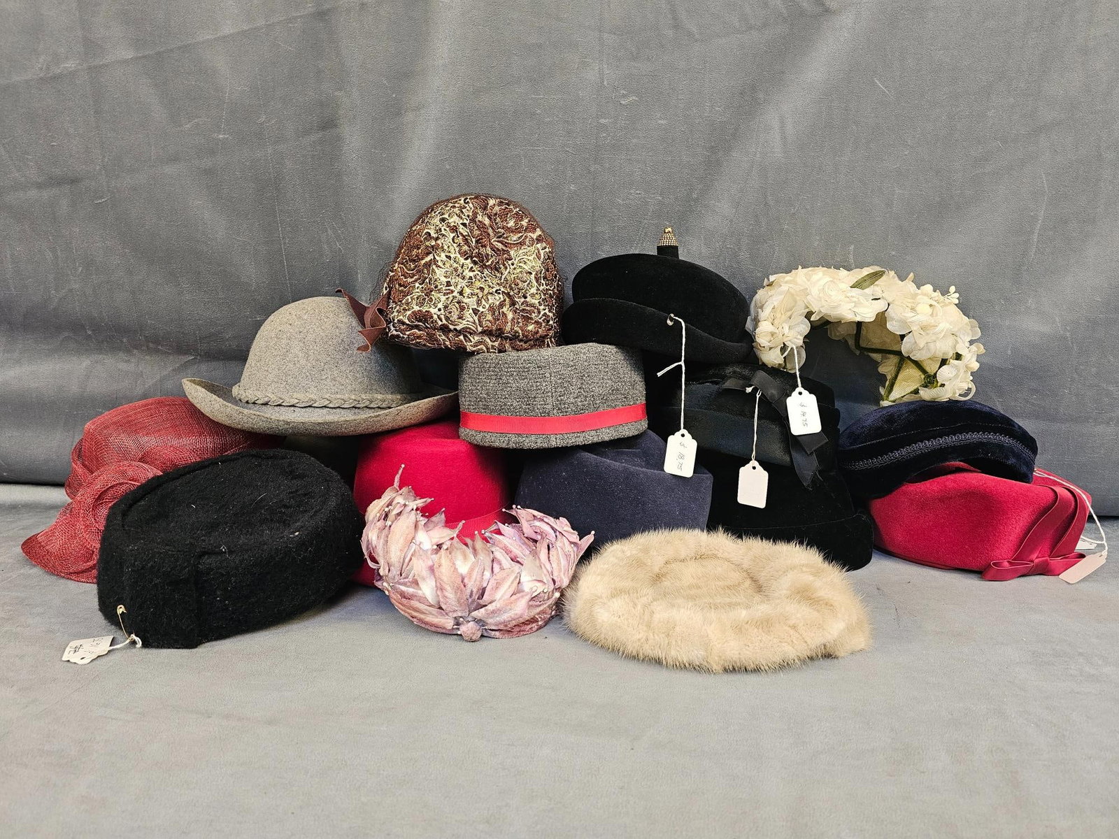 Ladies Hats: Fifteen vintage ladies hats in various styles. Brands include Peachbloom Velour, Mr. Charles, Holland Hat Co., and more. Largest measures 12.5 inches wide x 4.5 inches tall.