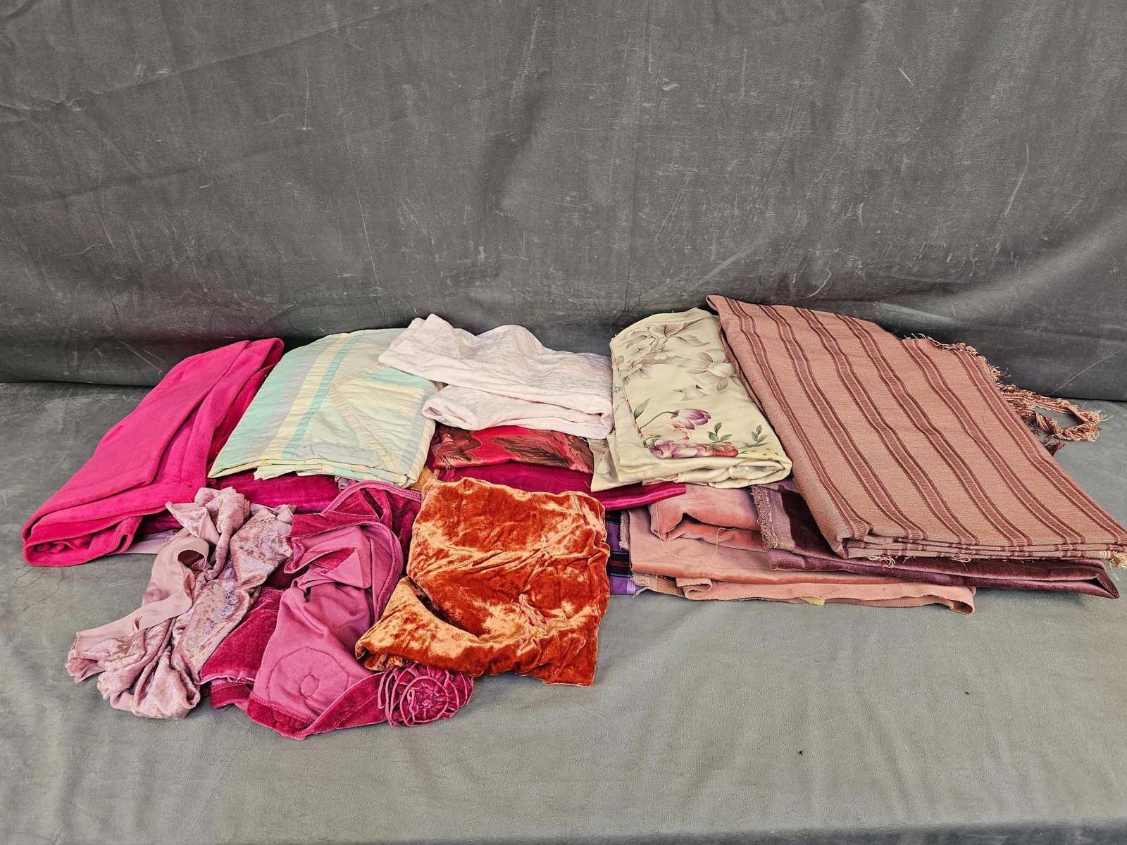 Vintage Fabric: Large group of vintage fabric. Fabric types include upholstery, velour type, cotton, synthetic, and more. Various sizes and conditions, not all pieces unfolded and examined.