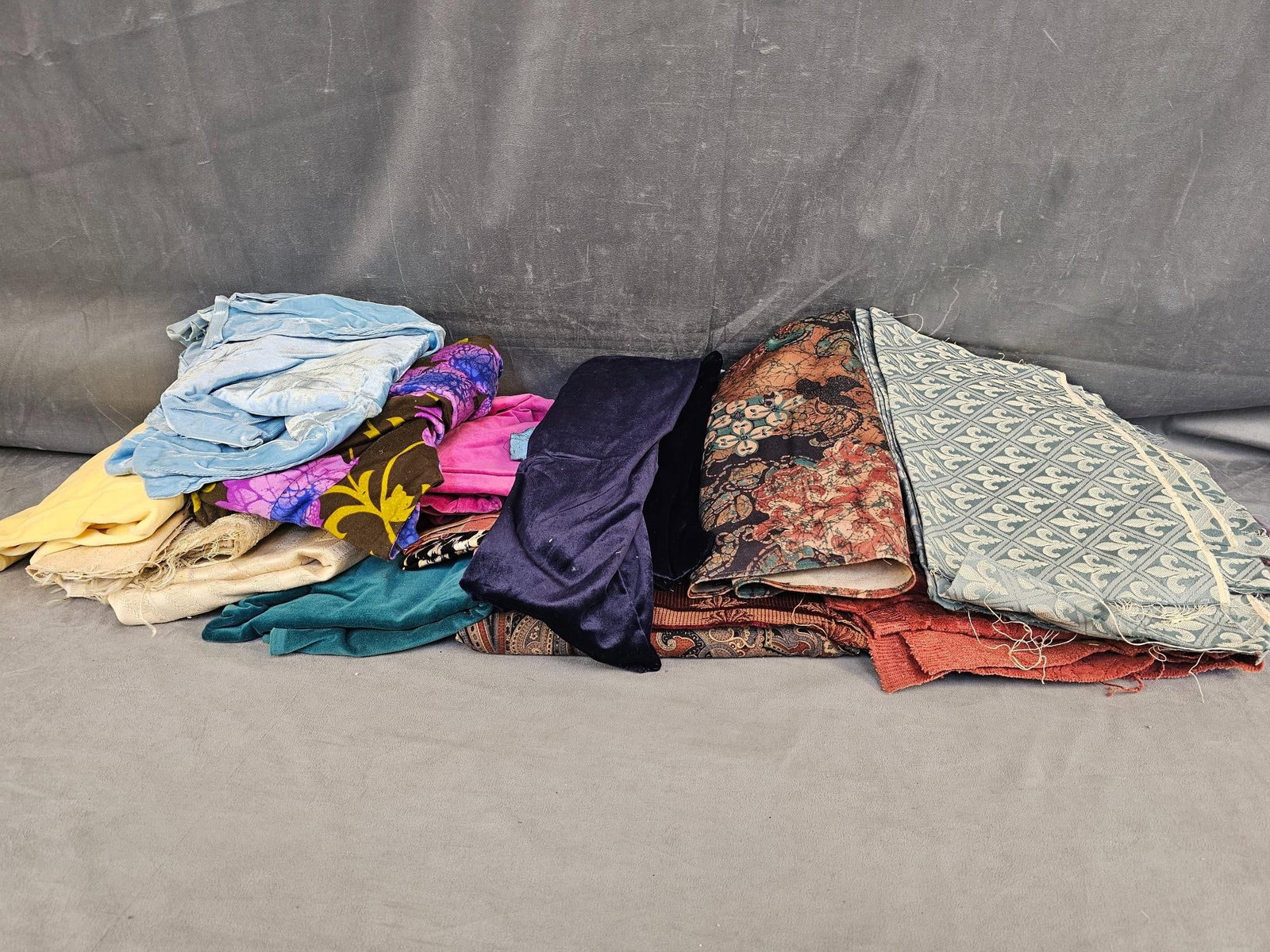 Vintage Fabric: Large group of vintage fabric. Fabric types include upholstery, velour type, cotton, synthetic, and more. Various sizes and conditions, not all pieces unfolded and examined.