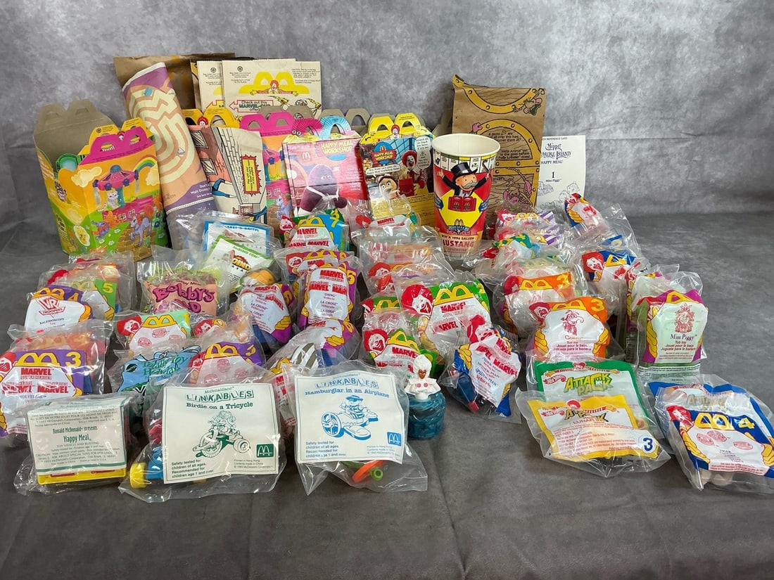 1993-1996 McDonald's Toys: Fifty 1900's Happy Meal toys. Includes the Muppets, Marvel vehicles and heroes, Attack Pack, McDinos and more. Includes bags and Happy Meal boxes. Toys are in original packaging. Average package