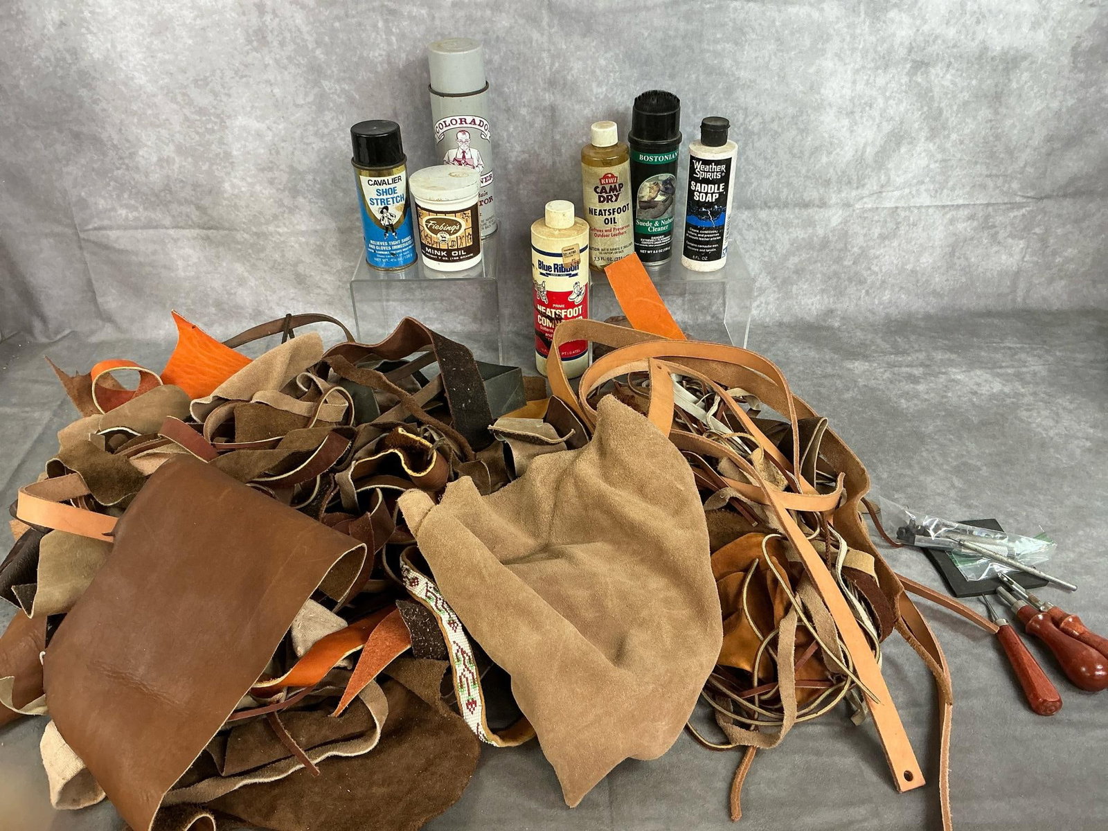 Lot of Leather Pieces, Strips, & Conditioners: Huge lot of leather pieces. Varied colors and thickness. Includes Neatsfoot Oil, Saddle Soap, Mink Oil and more for leather working. Also leather punch tools. Largest leather piece measures 26 inches