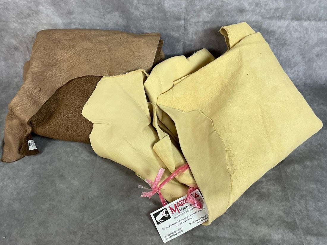 Large Animal Hides: Two buckskin hides, light and dark brown. Tanned and ready to use by Matoska Trading Company. Dark piece measures 28 inches wide x 46 inches long.
