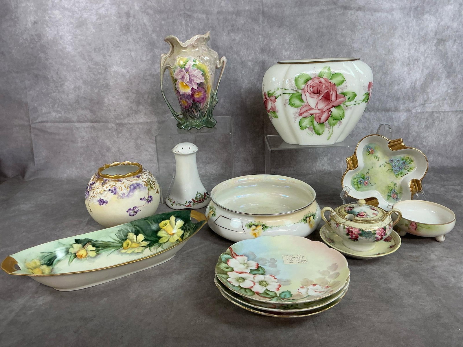 Hand Painted China Assortment: Twelve early to mid century pieces. Large oval white vase with roses signed by artist, bearded iris hand painted vase, round Royal Rochester baking dish, and round violets with gold trim vase.
