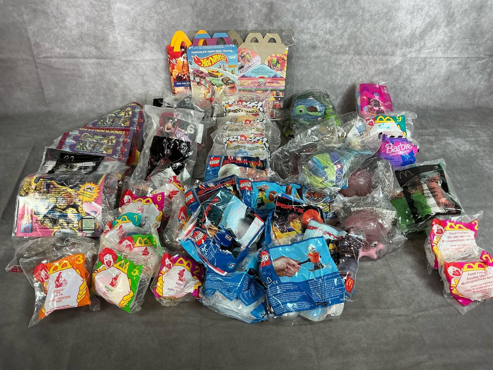 Collectible McDonald's Toys: Forty Happy Meal toys. Included are Legos, Mighty Dinos, Neverland, Barbie, Spy Kids 3D, Halloween toys, Jungle Book and more. Original packaging.
