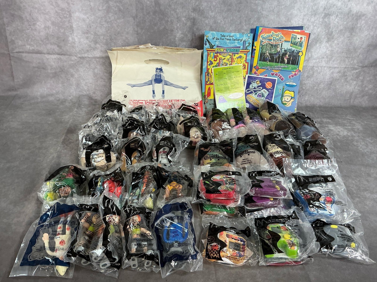 Happy Meal Collectibles: Forty-three collectible toys from 2001-2004. Includes ESPN game toy, the Country Bears, The Dog, Kim Possible, and Lilo & Stitch. Bags and boxes included. Toys in original packaging.