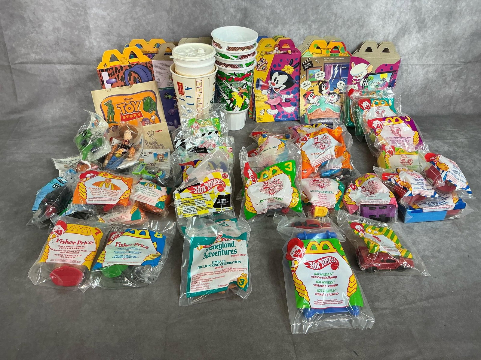 McDonald's & Burger King Toys: Thirty-seven toys from 1993- 1995. Burger King "Toy Story", Happy Meal toys include Animaniacs, The Busy World of Richard Scarry, Hotwheels, Halloween and more. In original packaging. Includes cups,