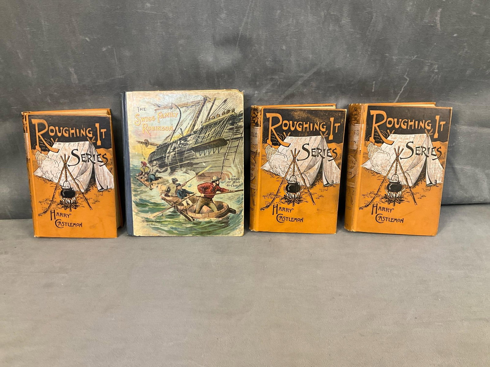 Victorian Children's Books: Four late 19th century children's books. One “The Swiss Family Robinson In Words of One Syllable “ with colored illustrations. Good used condition. Three circa 1881 Roughing It Series Books by