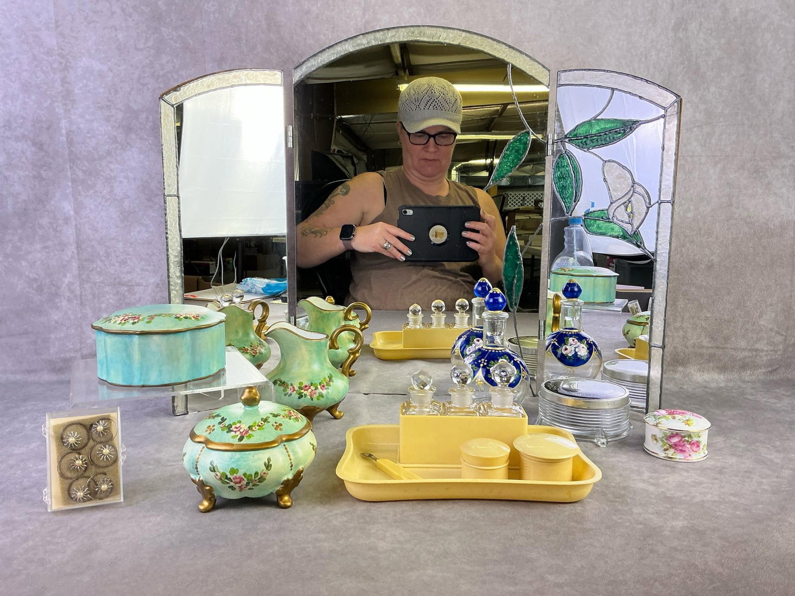 Stained Glass, Celluloid, & More: Stained glass trifold mirror, five piece celluloid dresser set, hand painted perfume bottle, and more. All in good condition. Mirror measures 21.5 inches wide x 17.75 inches tall.