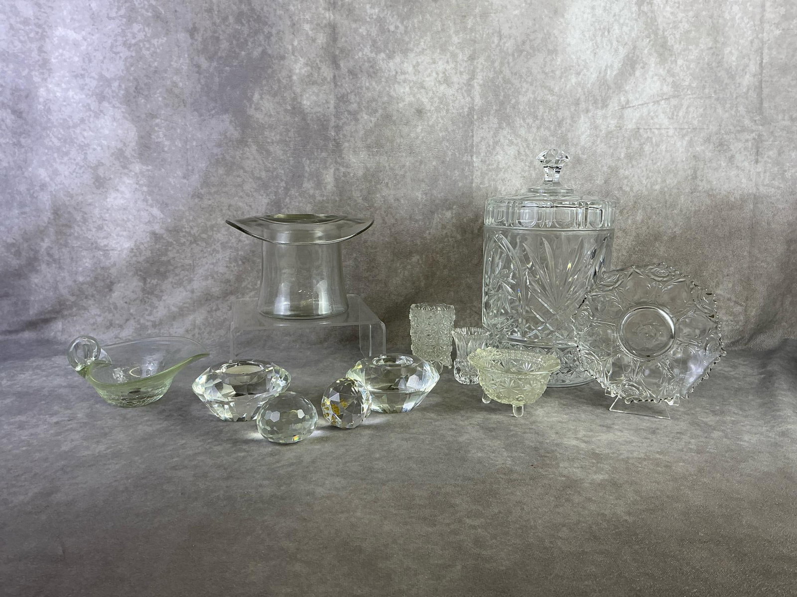 Glassware: Lot of glassware included candy jar, top hat, toothpick holders, candle holders, paperweight and more. All in good condition. Candy jar measures 6.25 inches wide x 11.5 inches tall.