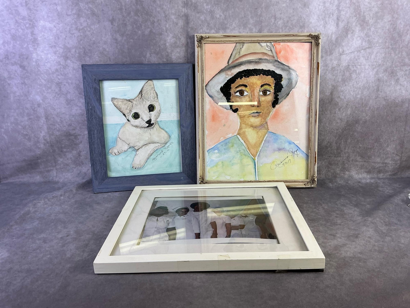 Rosamond Rogers Art & More: Two Rosamond Rogers art pieces one depicting a cat and the other depicting a woman. Also nursing team framed photo. All in fair to good condition. Largest measures 14.75 inches wide x 12.75 inches