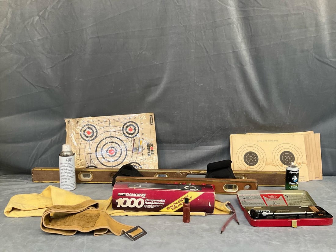 Gunner's Medley: An assortment of approximately a dozen vintage, mid-twentieth century gun related items. One Coleman 1000 Rangefinder in original box, one Chamois cloth protective gun sleeve/bag, one Stanley 4ft.
