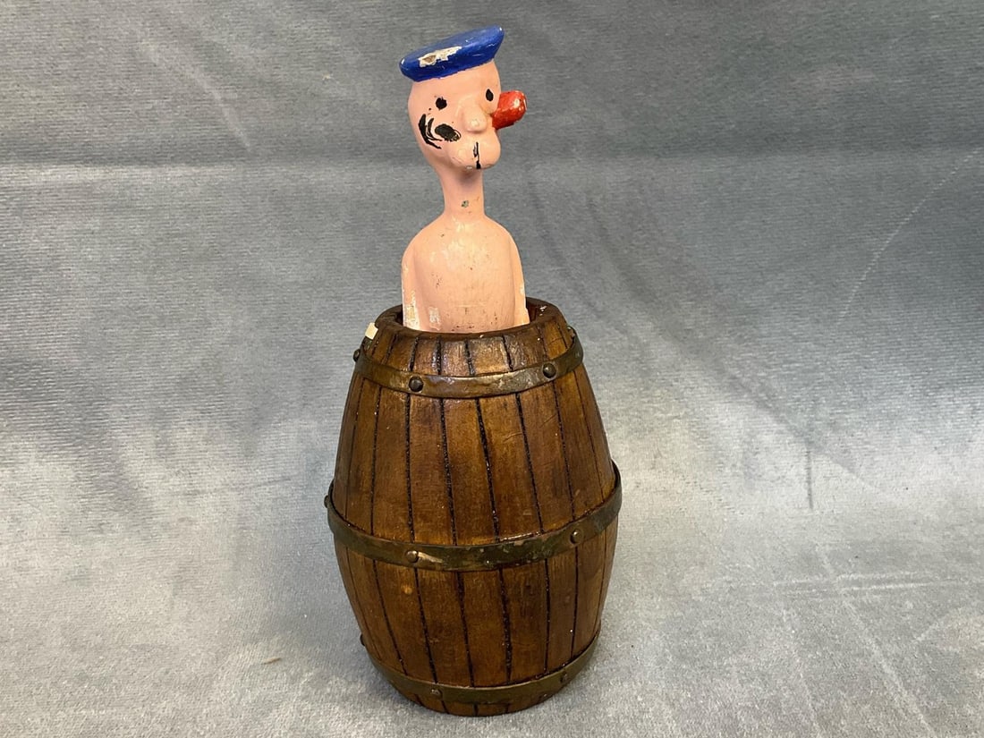 Popeye Toy: 1940's Popeye pop up in a barrel adult comical nude toy. Wooden barrel and composite Popeye. Missing pull string/chain and some paint loss to Popeye, otherwise good condition. Measures 2.5 inches