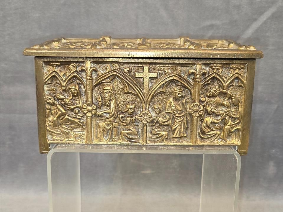 Brass Reliquary Box: Late 19th - early 20th century brass Northern European brass reliquary casket/box/jewelry box with stations of the cross decoration and a pair of brass miniature shoes. See attached consignor note