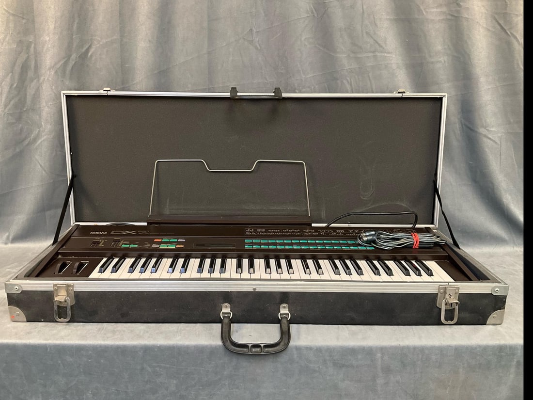 Yamaha Keyboard: 1986 vintage Yamaha DX7 Model Keyboard with case. Used condition. Powers on but not tested. Case measures 42.5 inches wide x 6 x 16 inches tall.