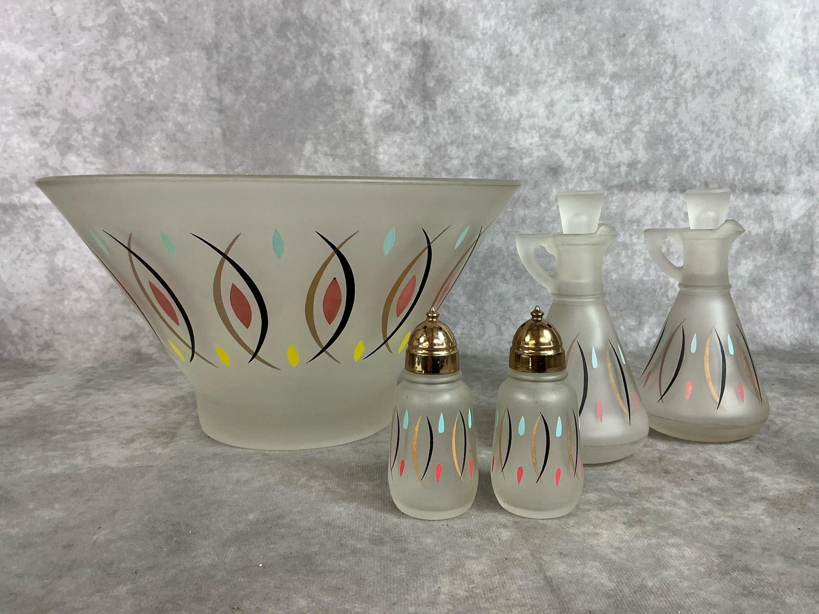 Atomic Pattern Salad Set: Vintage frosted glass bowl, oil and vinegar cruets, and salt and pepper shakers. Hazel Atlas "Atomic" pattern. In good condition. Measures 11 inches in diameter x 6 inches tall.
