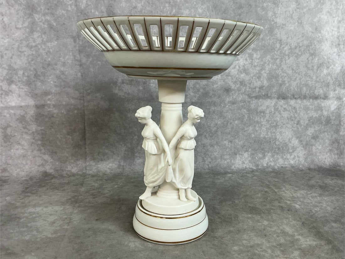 Ardalt Compote: Mid 1900's white porcelain pedestal compote. Ardalt Lenwile China from Japan with three bisque Neoclassical figures and gold trim. In good condition. Measures 9 inches in diameter x 10.75 inches tall.