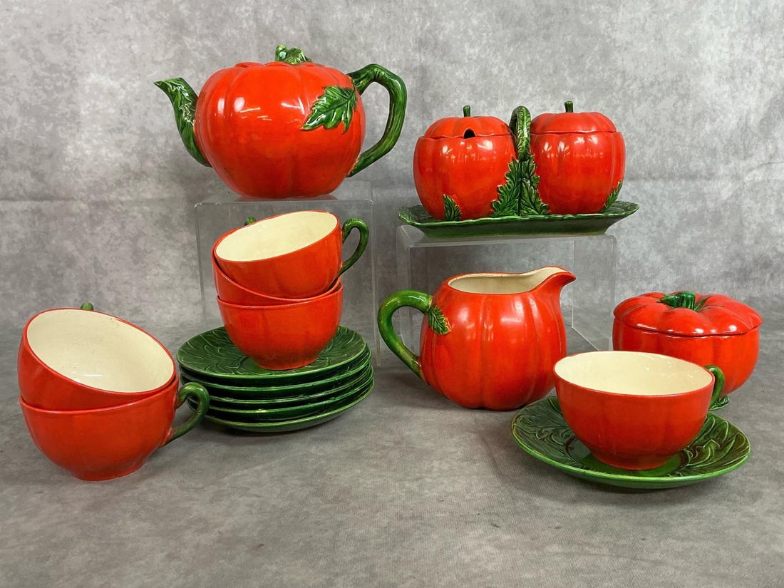 Tomato Ware Tea Set: Seventeen mid 1900's tea set. Maruhon tomato ware set includes teapot, cups and saucers, creamer and sugar, and jelly bowl set. Some crazing present, otherwise in good condition. Teapot measures 9 inc