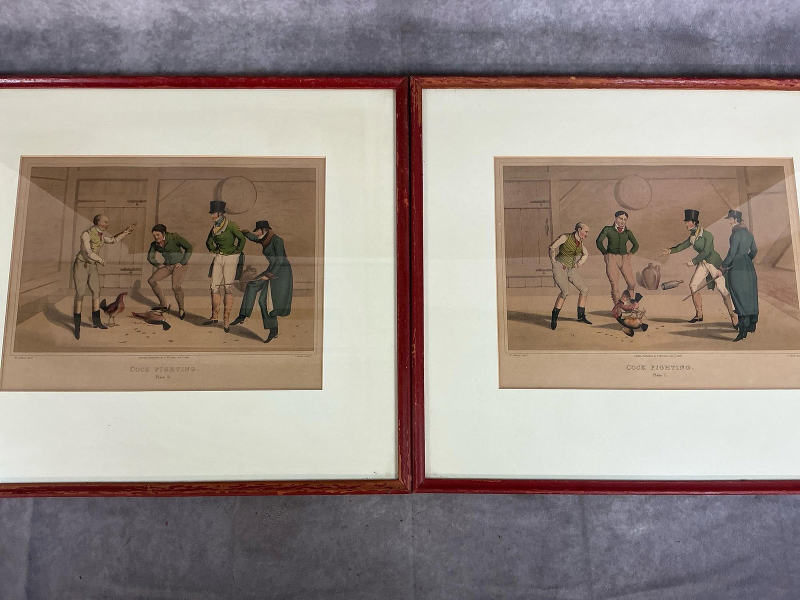 Cock Fighting Lithographs: Two vintage lithographs from pictures published by Henry Alken in 1820. Aquatint etching hand colored, matted and framed plate 1 and plate 2 of "Cock Fighting". In good condition. Measures 19.5
