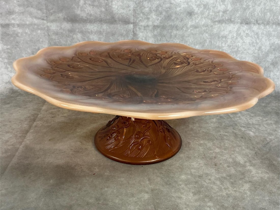 Fenton Cake Stand: Vintage Fenton pedestal cake stand. "Lily of the Valley" amber opalescent stand with floral relief on base and surface. In good condition. Measures 13 inches in diameter x 4.5 inches tall.