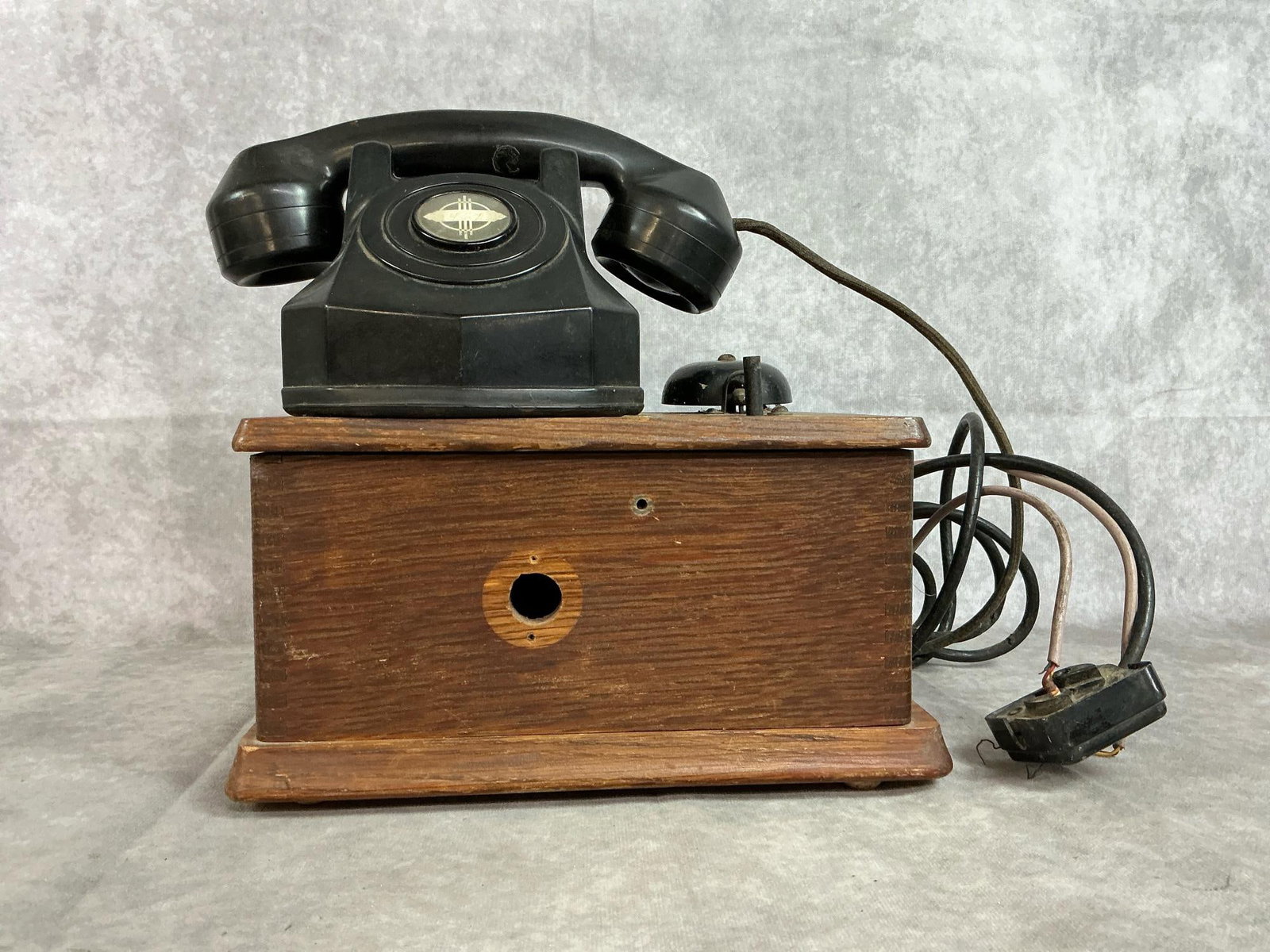 Vintage Telephone: Early 1900's Bakelite telephone attached to oak box. Box contains "workings" with bell attached to top of box. Untested. Box measures 10.25 inches wide x 8.25 x 10.5 inches tall including phone.