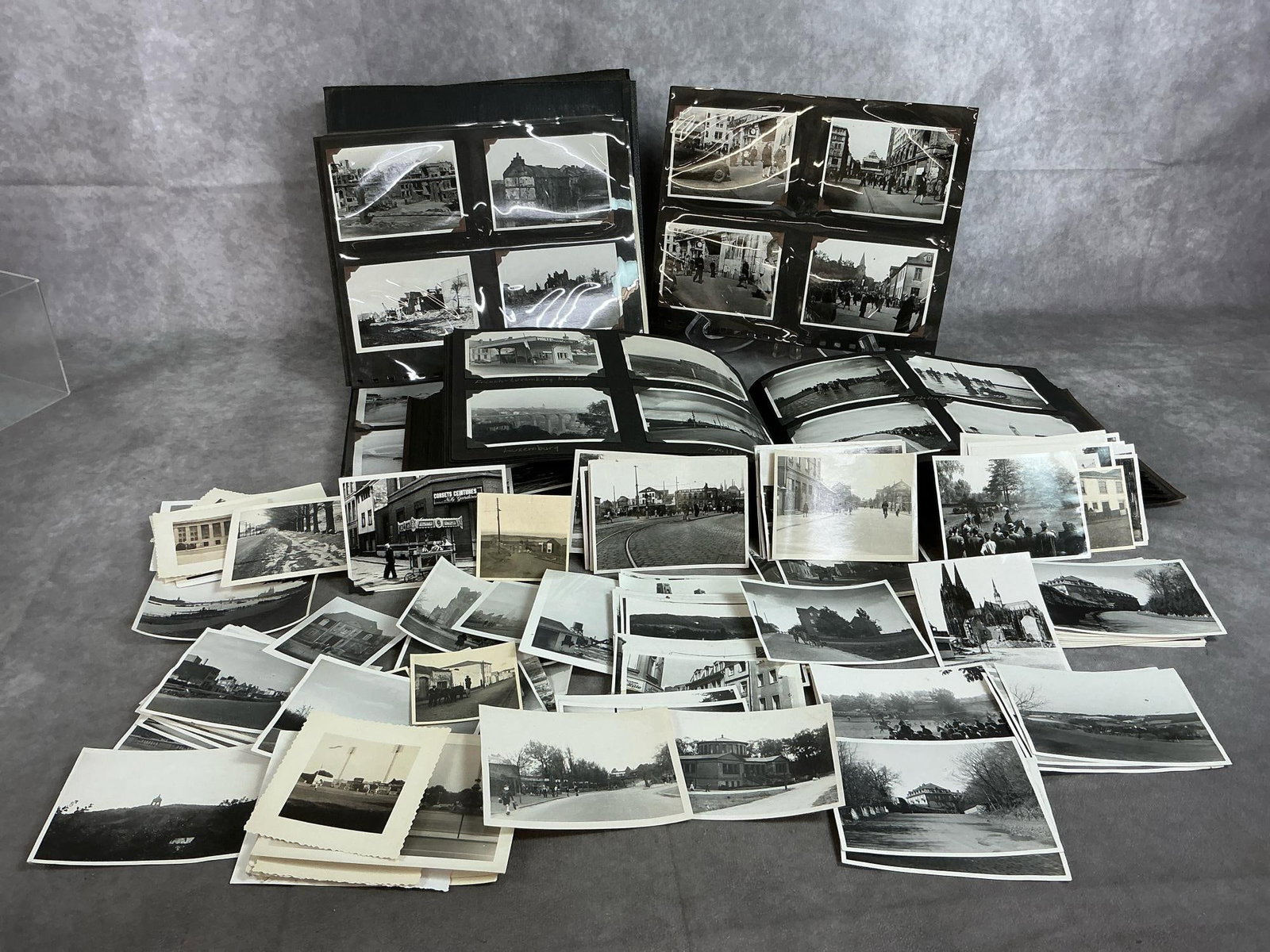 Vintage Photos from Around the World: Early to mid 1900's black and white photos. Two albums and loose pictures totaling over 100 photos. Most are of places including the United States, England, France, and Germany. Largest album