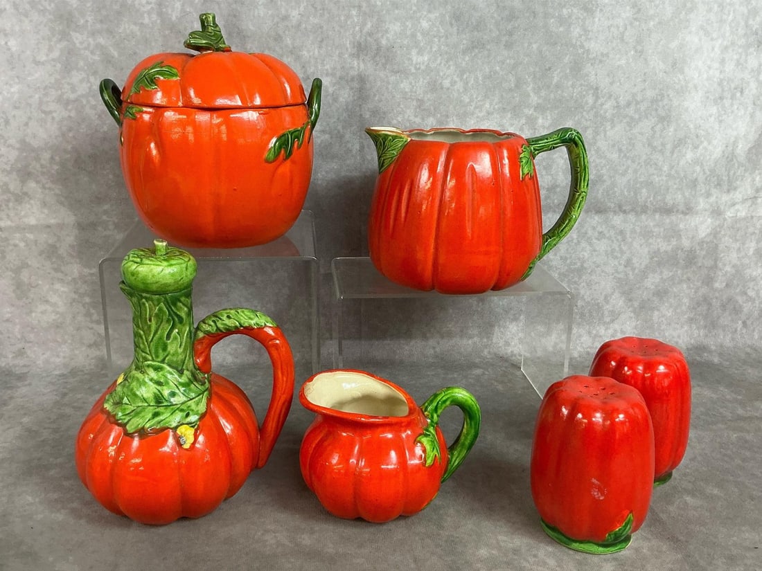 Tomato Ware Set: Six mid century pieces of Maruhon tomato ware from Japan. Includes jar with lid, pitcher, salt and pepper, creamer, and cruet. In good condition. Pitcher measures 6.5 inches wide x 5 inches tall.