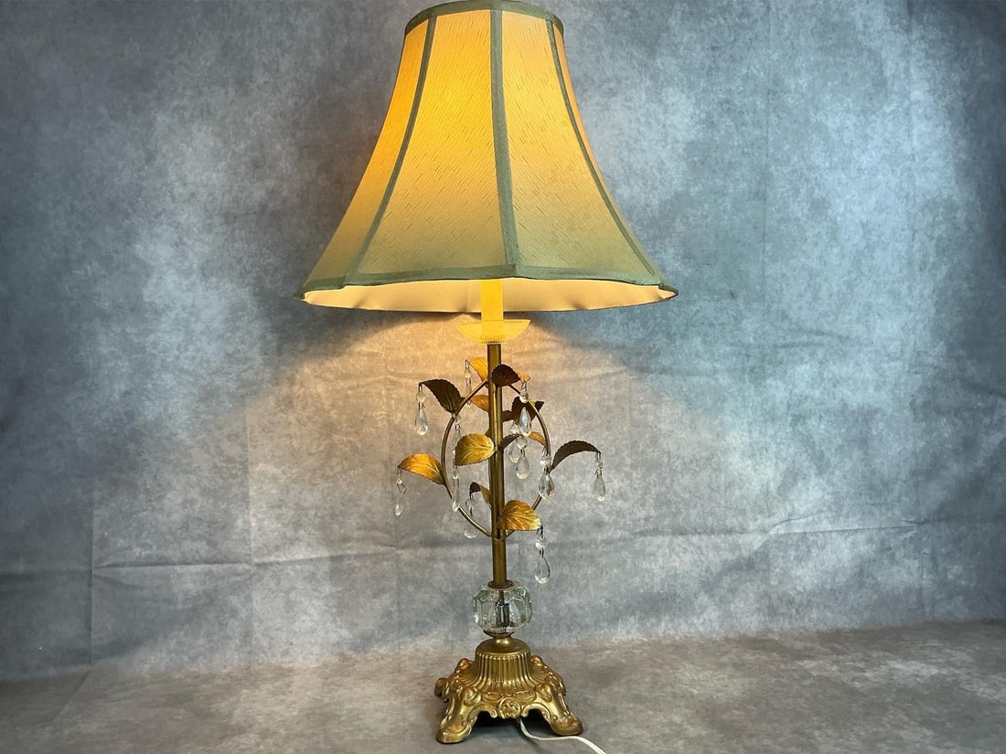 Italian Table Lamp: Vintage Italian tole table lamp with gold finish. Leaf design with crystal prisms and heavy metal base. Works well. Measures 9 inches wide at center x 31 inches tall including shade.