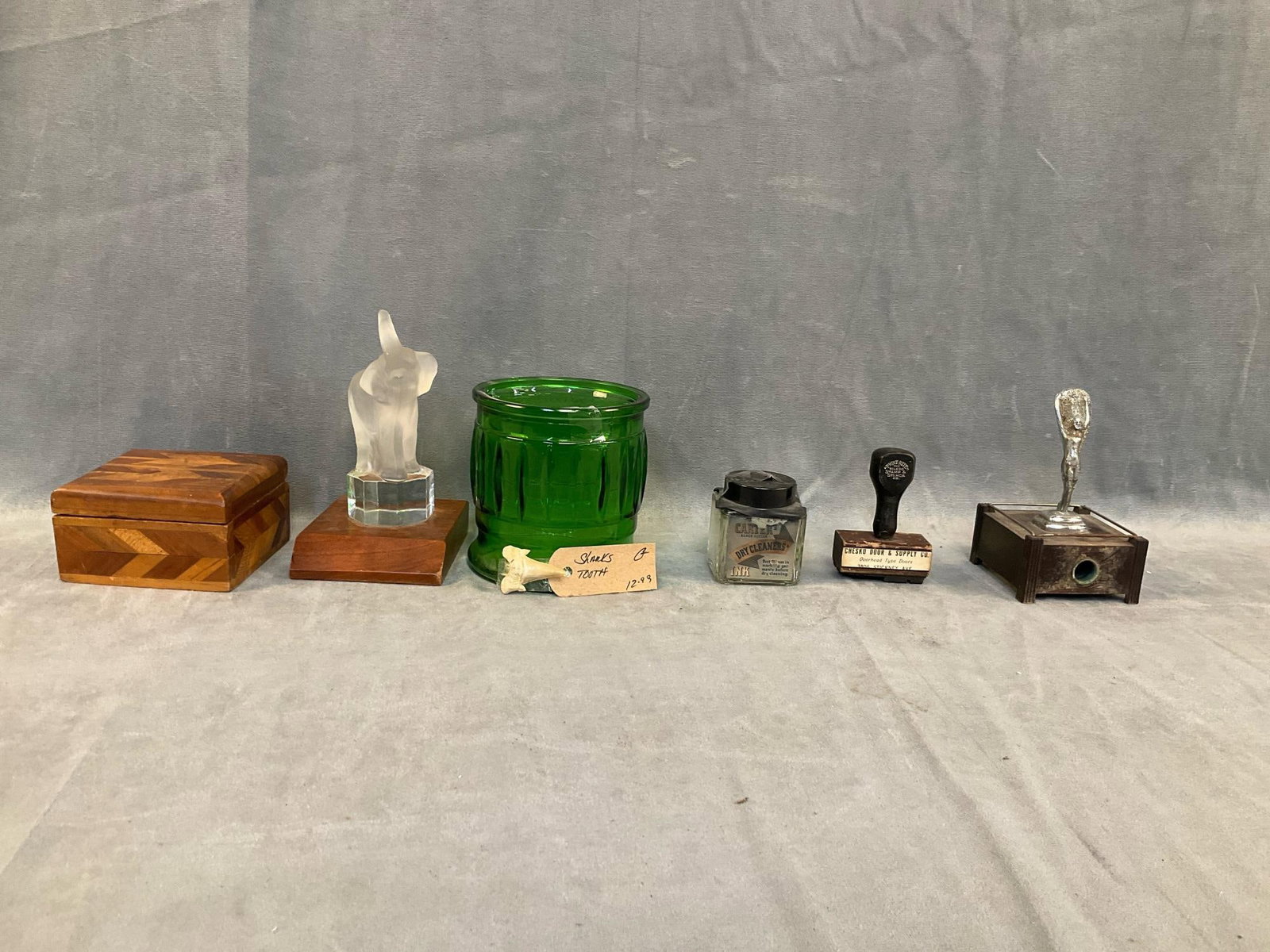 Miscellaneous Vintage: Lot of seven early 20th century vintage collectible items. One inlaid folk art box. One glass elephant desk top decorative accessory. One shark tooth. One green glass canister. One Dry Cleaners Ink wi