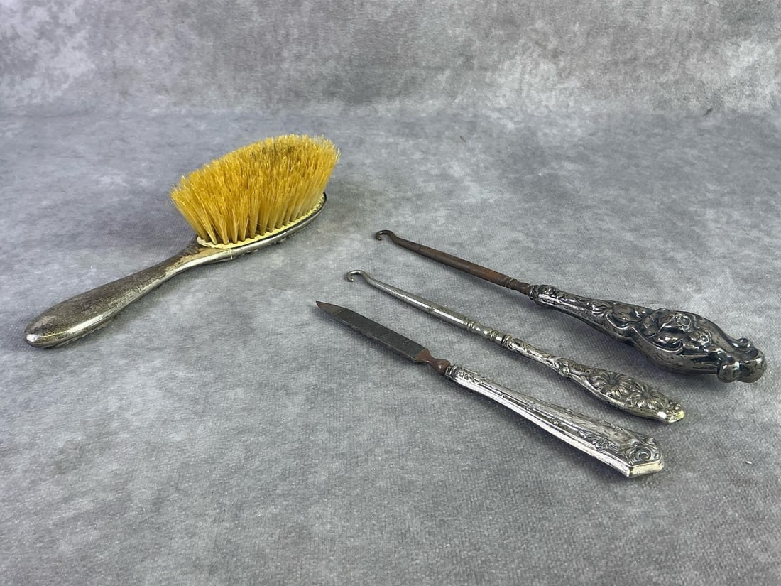 Sterling Silver Vanity Finds: Sterling silver hair brush, nail file, and two button hooks. All stamped and in good condition with oxidation present. Total weight 5.9 ozt.