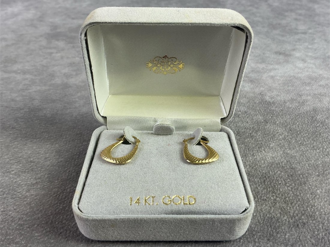 14kt Earrings: Pair of 14kt gold hoop earrings. In good condition, stamped. Total weight 0.3 dwt.