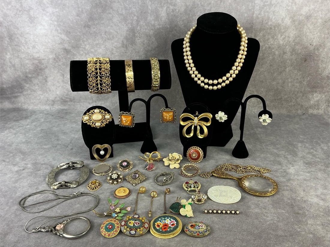 Costume Jewelry: Thirty five pieces of vintage costume jewelry including a Whiting and Davis bracelet, four micro mosaic brooches, ladies magnifying glasses, and more. Other brands include Napier, BSK, Sarah